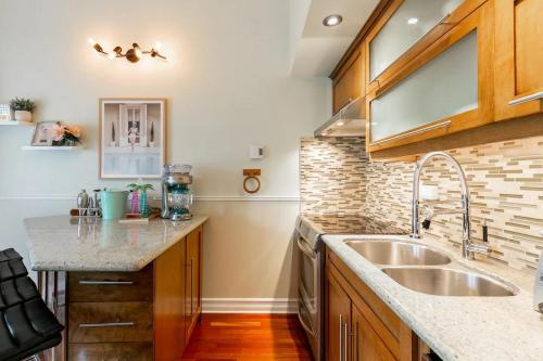 a kitchen with a sink and a counter at Charming Tremblant 1 Bedroom -Pool Hot Tub in Mont-Tremblant