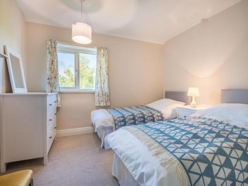 a bedroom with two beds and a window at 3 Bed in Braithwaite SZ045 in Braithwaite
