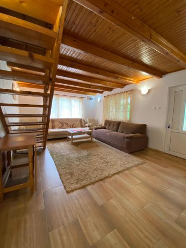 a living room with a couch and a table at PENSIUNEA STEFANIA in Brebu Mînăstirei