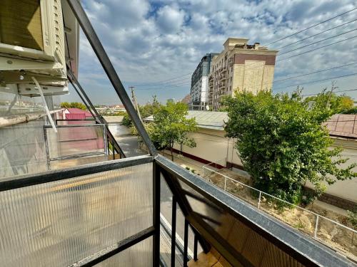 a balcony with a view of a city at Komolon in Tashkent