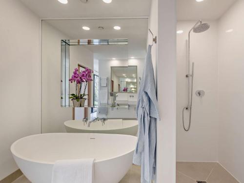 a white bathroom with a tub and a sink at 1 Bed in Yelverton 88860 in Bere Alston