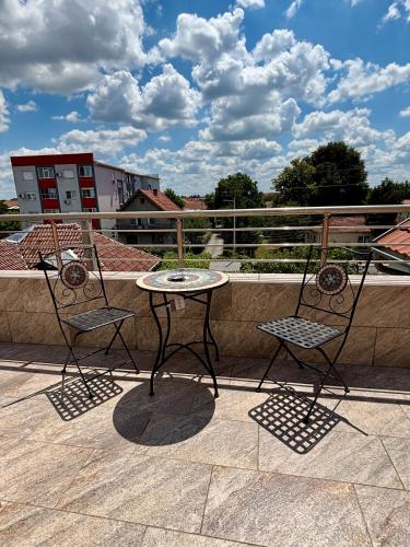 two chairs and a table on a patio at Apartment Milos in Belgrade