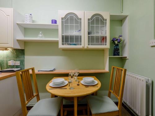 a kitchen with a wooden table and chairs at 1 Bed in Fordingbridge 89512 in Fordingbridge