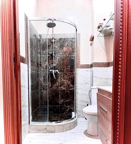a shower with a glass door in a bathroom at Casa Amy in Mohammedia