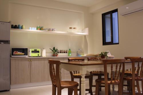 a kitchen with a table and chairs and a counter at Mysig in Luodong