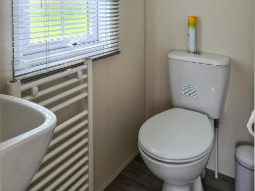 a bathroom with a toilet and a sink and a window at Castle Campbell View in Dollar