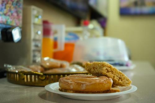 two donuts sitting on a plate on a table at Travel Inn in Sunnyside