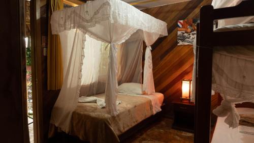 a bed with a canopy in a room at Shandia Lodge in Tena