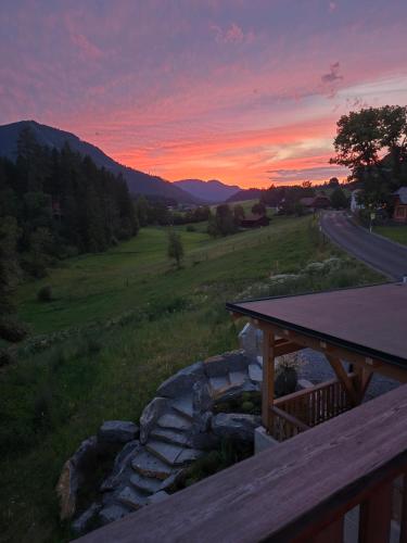 a sunset from the deck of a house with a road at Riesenbauer in Zeutschach