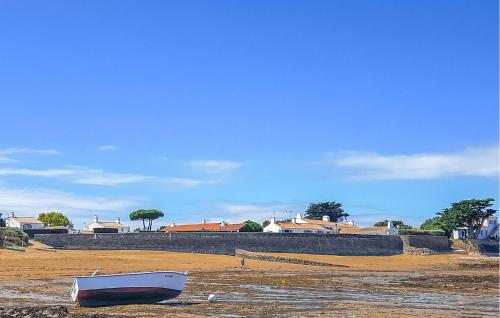 a boat sitting on the ground on a beach at Stunning Home In Noirmoutier En Lile in Noirmoutier-en-l'lle