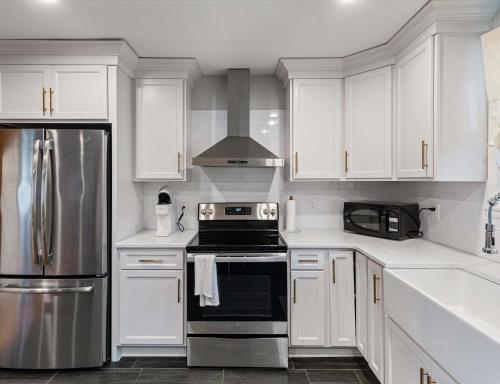 a kitchen with white cabinets and a stove top oven at Cozy Franklin Hideaway - For 5 in Franklin
