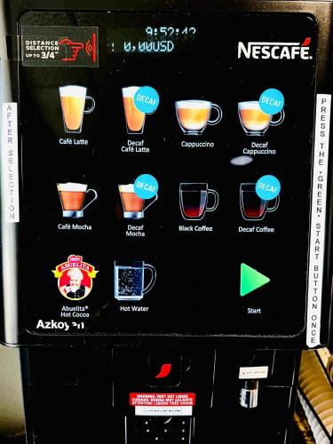 a vending machine with different types of coffee cups at Microtel Inn & Suites by Wyndham Austin Airport in Austin