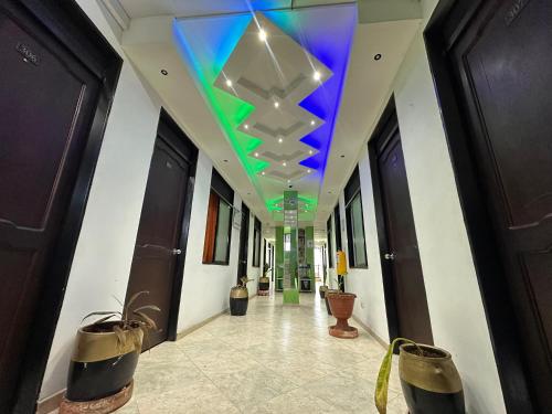 a hallway with a blue and green ceiling at Emporio Real Hotel in Yopal