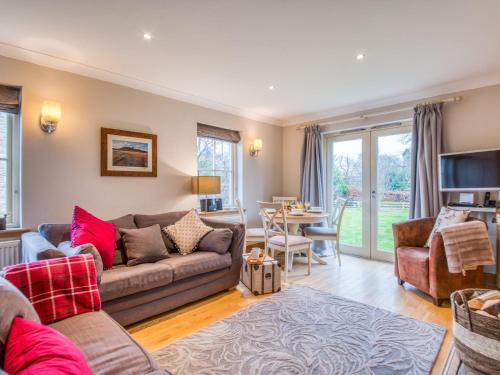 a living room with a couch and a tv and a table at 2 Bed in Nr Beadnell 77990 in Ellingham