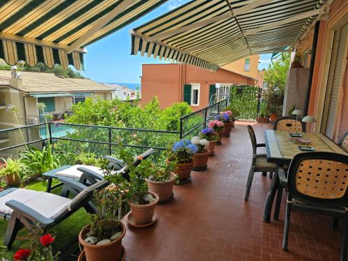 a balcony with tables and chairs and potted plants at Casa Anna Maria in Monterosso al Mare