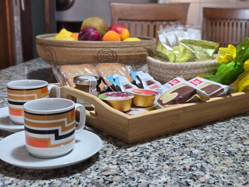 a wooden tray of food with two cups of coffee at Casa Anna Maria in Monterosso al Mare