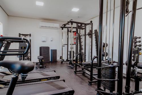 a gym with rows of treadmills and machines at Bee Guest - Apartamentos de Temporada Luxxor Flat in Cuiabá