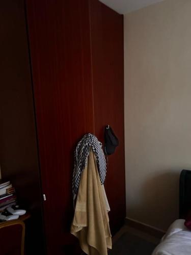 a towel hanging on a door in a bedroom at Axis Guest House in Syokimau