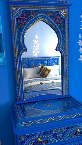 a blue bedroom with a bed in a blue room at CASA AMRANi in Chefchaouene