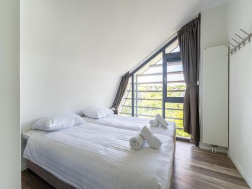 a bedroom with a bed with towels on it at Villa in Egmond near Beach & Windmill in Egmond aan den Hoef