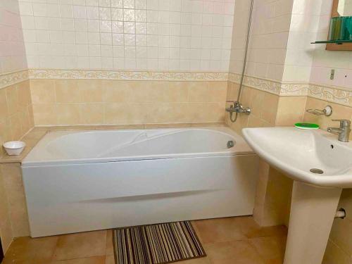 a bathroom with a white tub and a sink at Luxury Apartment, Kabila Vista, MDiq, Morocco in M'diq