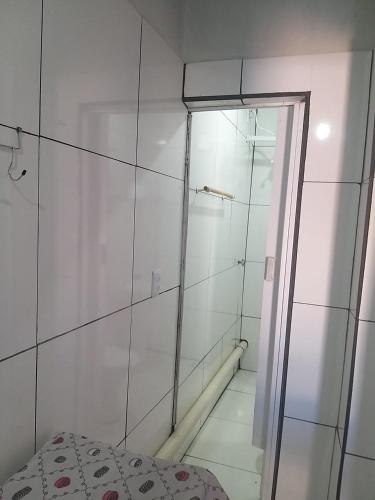 a bathroom with a shower and a glass door at Hospedagem 24 de Junho in Barra do Garças