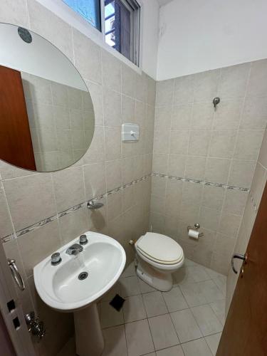 a bathroom with a toilet and a sink at Espacioso Departamento Céntrico in Formosa