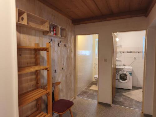 a bathroom with a washer and dryer in a room at Sport Apartments Tirol in Umhausen