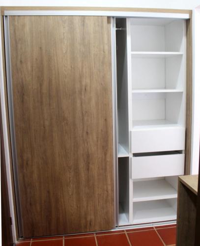 a closet with a wooden door and white shelves at Hotel El Arca, Jardín Botánico y Restaurante in Santa Bárbaraa