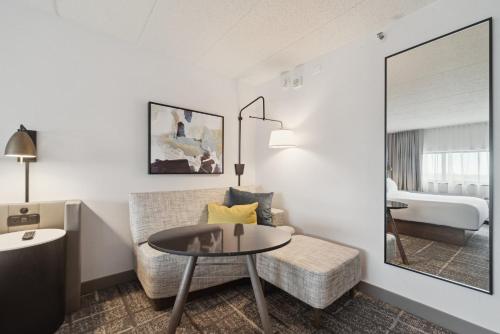 a living room with a couch and a table at Crowne Plaza Lansing by IHG in Lansing