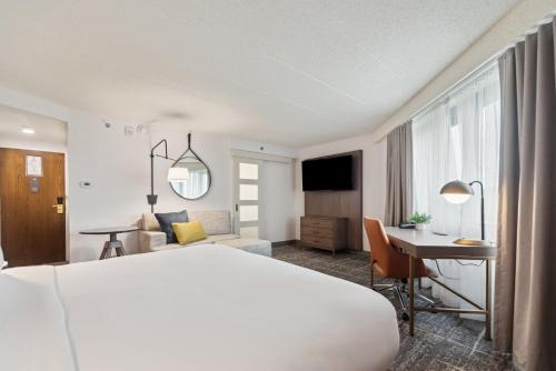 a hotel room with a bed and a desk at Crowne Plaza Lansing by IHG in Lansing