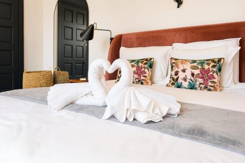 two swans made out of towels on a bed at City Penthouse with 3 floors , Super King Bed , with secret garden in Birmingham