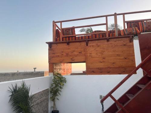 a balcony on top of a house in the desert at Atalanta Surf House in Imsouane