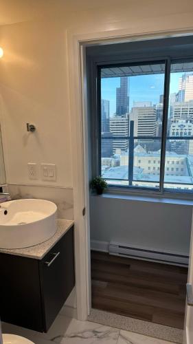a bathroom with a sink and a window with a view at Great view 1BDRM APTR in heart of Montreal DWTN in Montréal