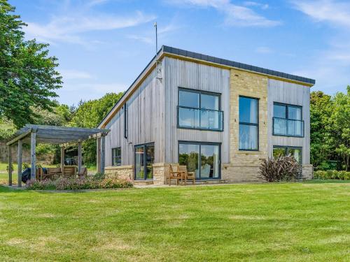 a barn style house with a lawn at Bellshill Bothy in Newlands