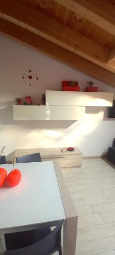 a room with a white table and white shelves at ValtellinaHome in Villa di Tirano