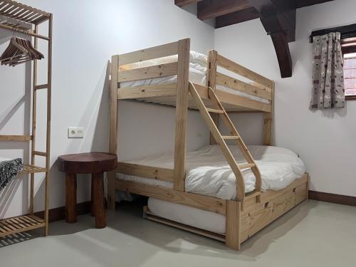 a wooden bunk bed with a ladder in a room at Olabe in Ea