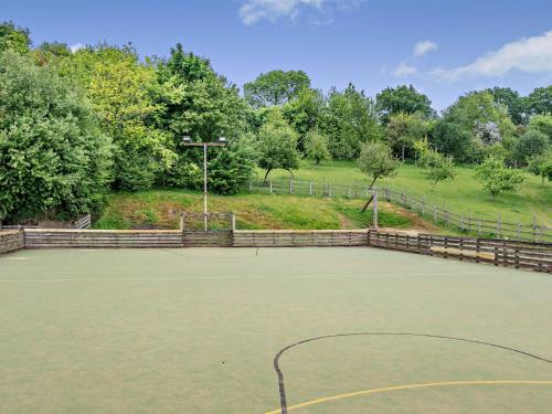 a tennis court with a basketball hoop on it at 3 Bed in Crediton WAIE3 in Zeal Monachorum
