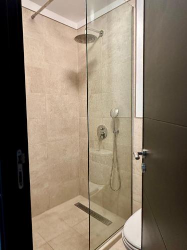 a bathroom with a glass shower with a toilet at Palacio de Sofia & Luxury in Asilah