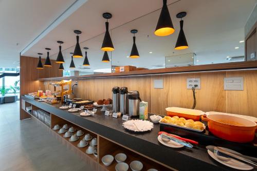 a buffet line in a restaurant with many lights at Soft Inn Alagoinhas in Alagoinhas