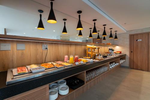 a buffet line with many different types of food at Soft Inn Alagoinhas in Alagoinhas