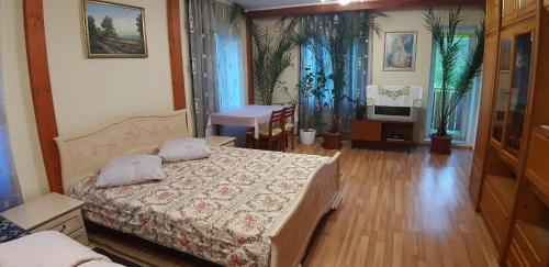 a bedroom with two beds and a table and a television at Садиба Сергія in Sinyak