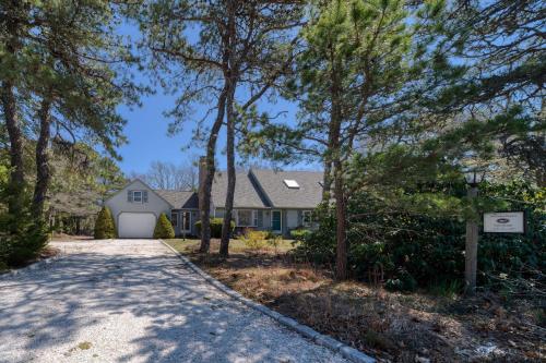 a driveway leading to a house with a garage at 4 Bedroom Home by Leavetown Vacations in Eastham
