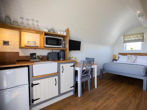 a kitchen and a bedroom with a bed in a room at 1 Bed in Teviothead 75347 in Hawick