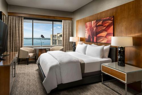 a hotel room with a bed and a large window at The Westin Harbour Castle, Toronto in Toronto