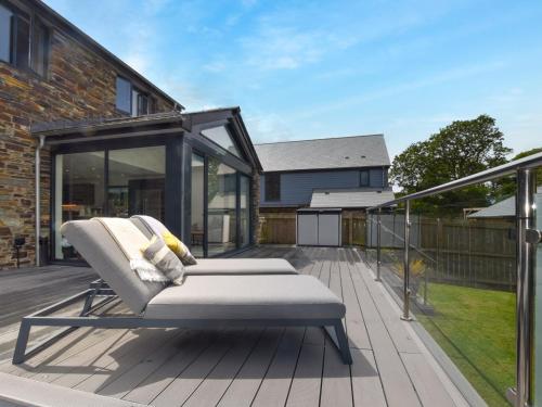 a bed on the deck of a house at 4 Bed in Bude 89355 in Poughill