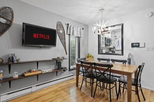a dining room with a table and chairs and a tv at Mt Snow Retreat - Walk to brewery in Dover