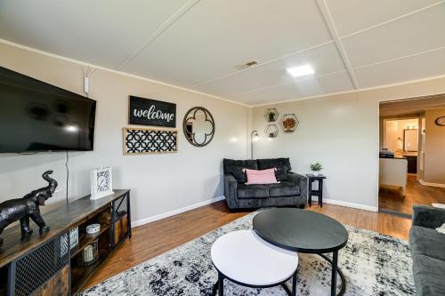a living room with a couch a table and a tv at Private Dock and Slip Kentucky Lake Cottage! in Buchanan