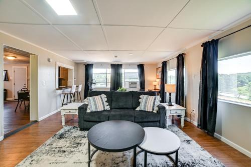 a living room with a couch and a table at Private Dock and Slip Kentucky Lake Cottage! in Buchanan