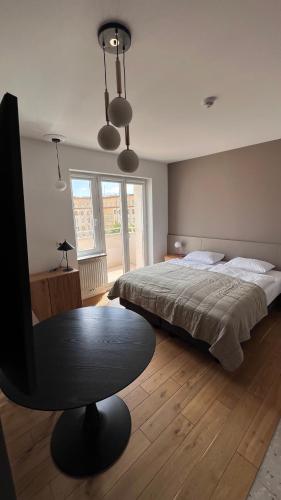 a bedroom with a bed and a table in it at Poziom Morza in Gdynia